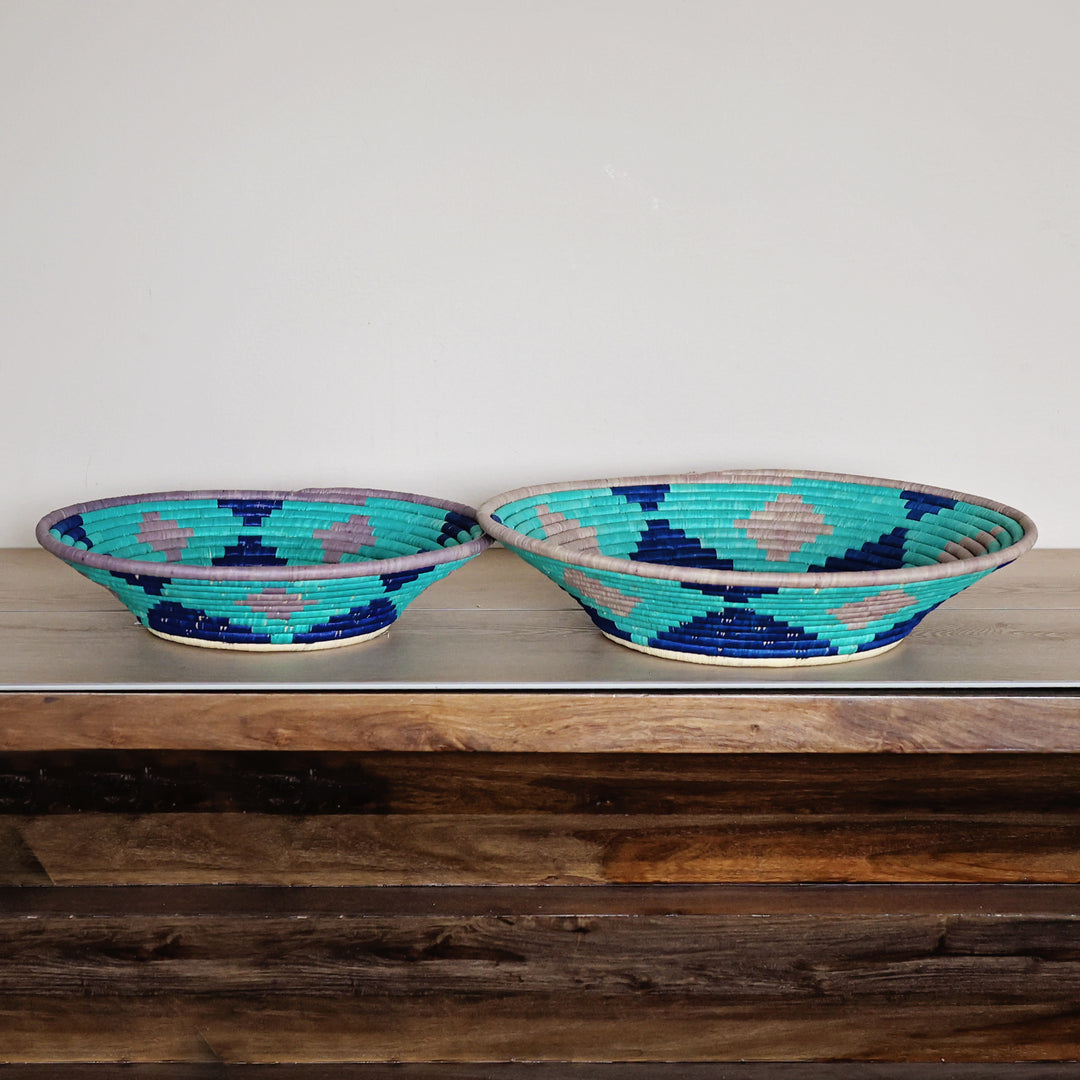 Side view of a Natural, Turquoise & Lilac Bukedo and Raffia bowl handcrafted in Uganda from banana leaf stalks and palm raffia.