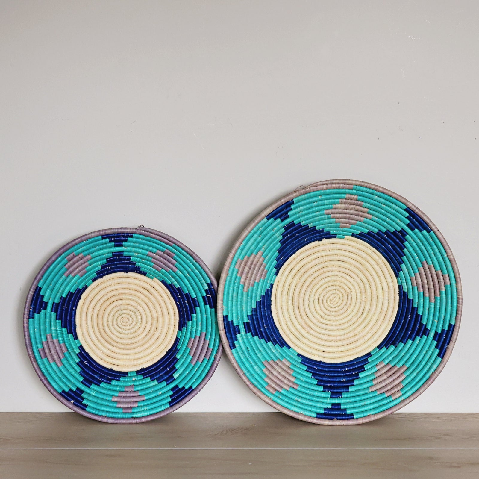 Handwoven Natural, Turquoise & Lilac Bukedo and Raffia bowl handmade in Uganda for fair trade wall décor and home styling.