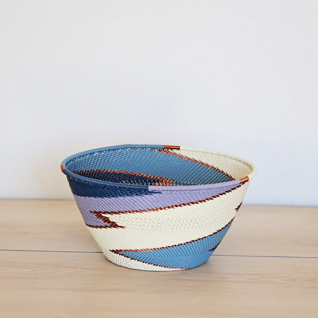 Ocean Zulu Deep Bowl handwoven in South Africa with rich ocean blue tones in a diagonal stripe pattern.