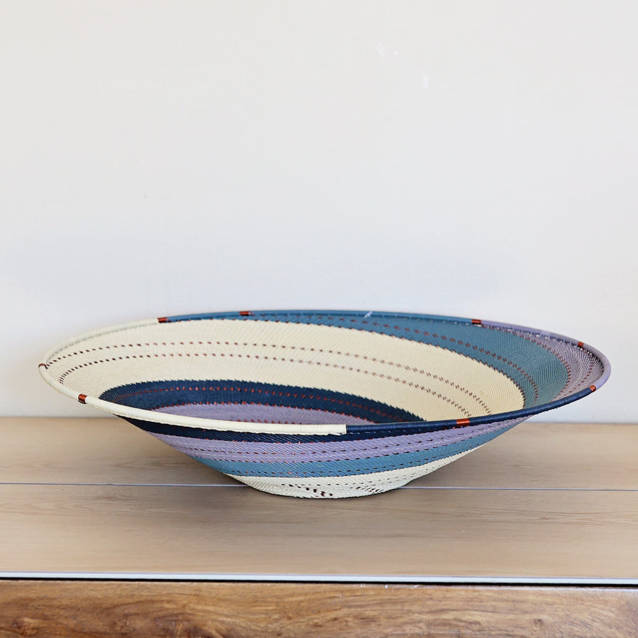 Ocean Zulu Extra Large Shallow Basket handwoven in South Africa with rich ocean blue tones in a diagonal stripe pattern.