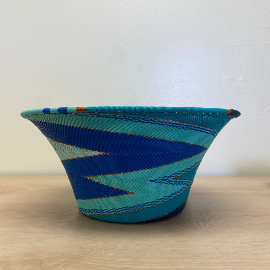 South African Zulu large flared wire basket with handwoven blue, aqua, navy and white striped detailing.
10.