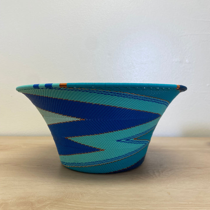 South African Zulu large flared wire basket with handwoven blue, aqua, navy and white striped detailing.
10.