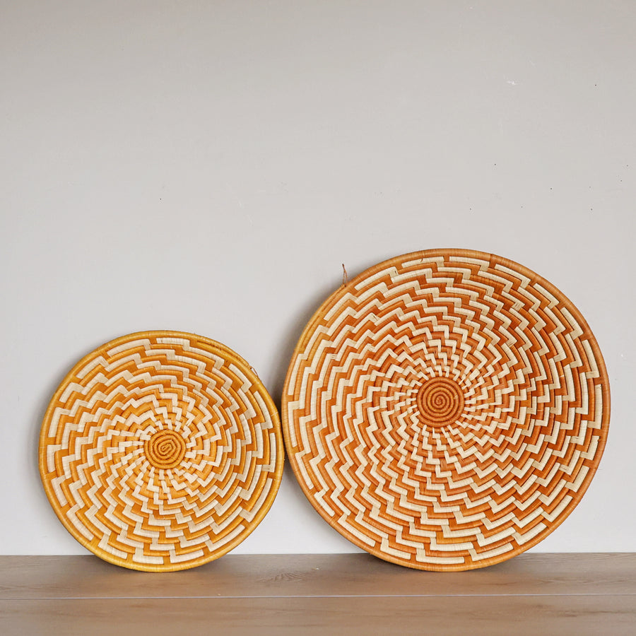 Handwoven Orange & White Bukedo and Raffia bowl handmade in Uganda featuring bold woven patterns for fair trade wall décor and home styling.