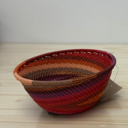 Orchid Zulu Wire wide bowls handwoven in South Africa in rich burgundy, berry, plum, and warm pink tones.