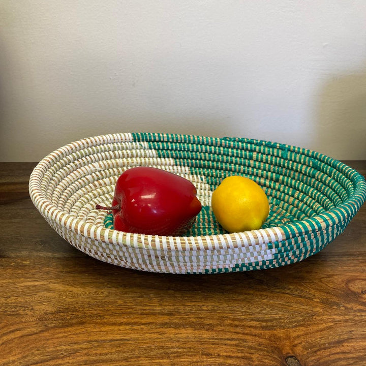 Assorted oval sweetgrass baskets in colorful patterns handmade in Senegal