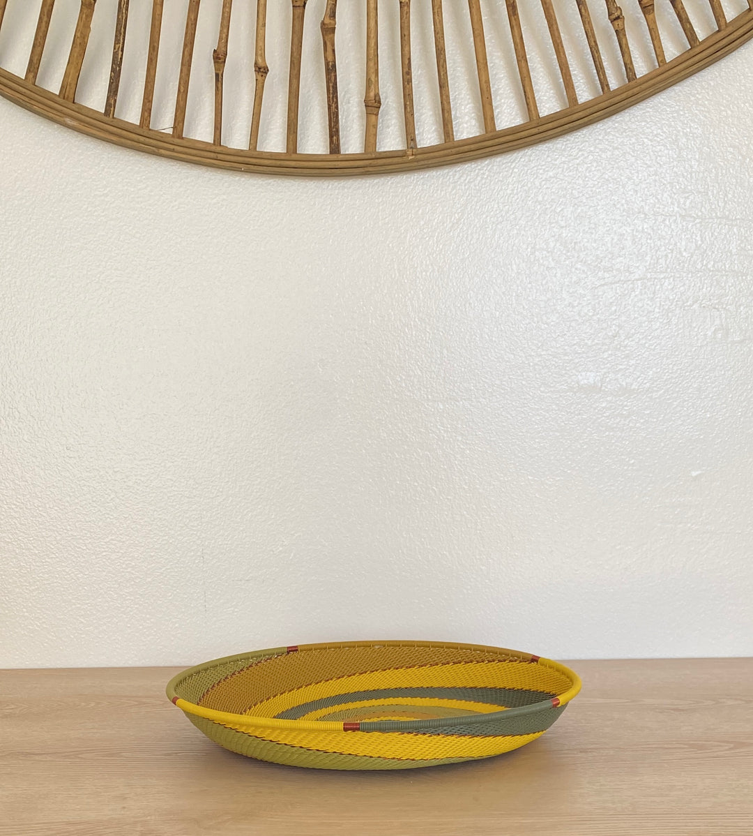 Papaya Zulu Large Tray handwoven in South Africa with sunny yellow and papaya orange in a diagonal stripe pattern.