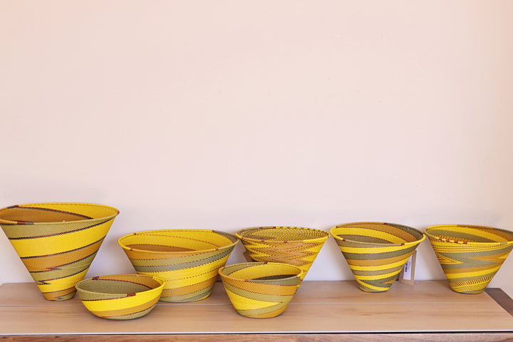Papaya Zulu Bowl handwoven in South Africa with sunny yellow and papaya orange in a diagonal stripe pattern.