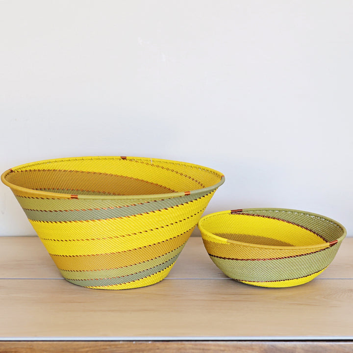 Papaya Zulu Deep Bowl handwoven in South Africa with sunny yellow and papaya orange in a diagonal stripe pattern.