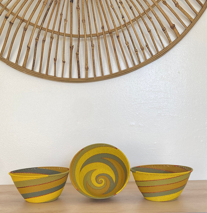 Papaya Zulu Deep Bowl handwoven in South Africa with sunny yellow and papaya orange in a diagonal stripe pattern.