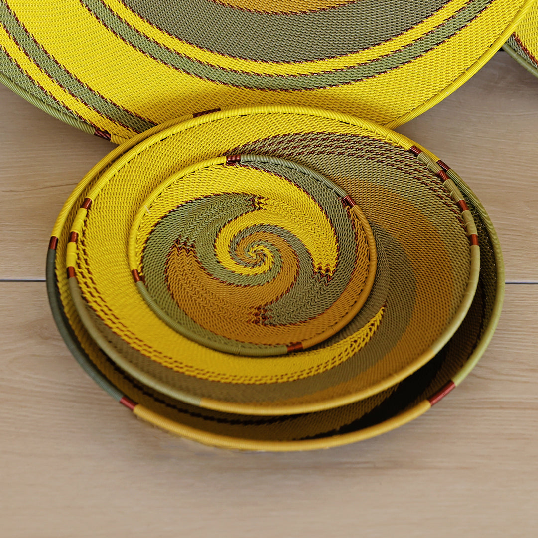 Papaya Zulu Medium Shallow Basket handwoven in South Africa with sunny yellow and papaya orange in a diagonal stripe pattern.