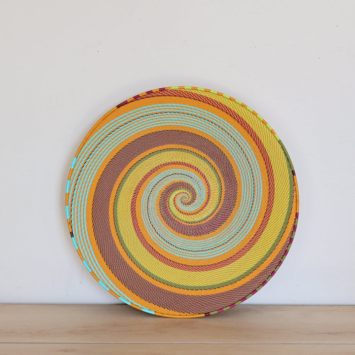 Pastel Zulu Extra Large Shallow Basket handwoven in South Africa with vibrant multicolor wire in an intricate spiral pattern.