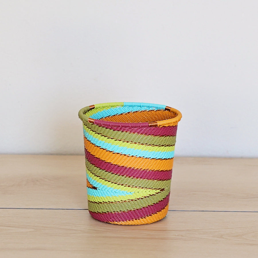 Pastel Zulu Wide Base Cup handwoven in South Africa with aqua, green, yellow, orange, and berry-colored wire accents.