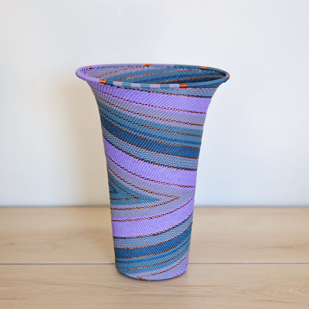 Purple Zulu Flared Top Vase handwoven in South Africa with layered shades of purple in a diagonal stripe pattern.
