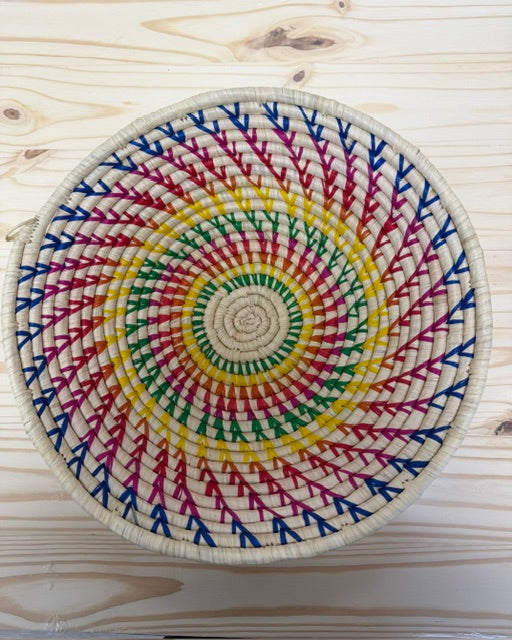 Small Rainbow Raffia Fruit Basket handwoven from sustainable raffia in a colorful radiating pattern.