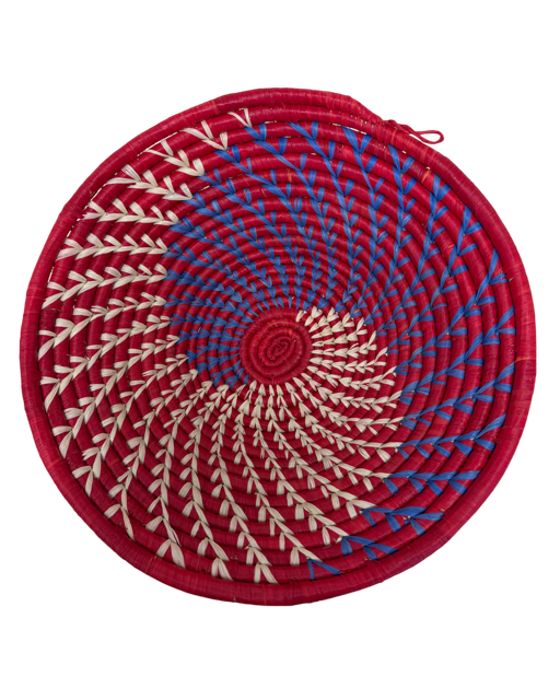 Red and blue spiral raffia bowls handwoven by African artisans in bold colorful patterns.