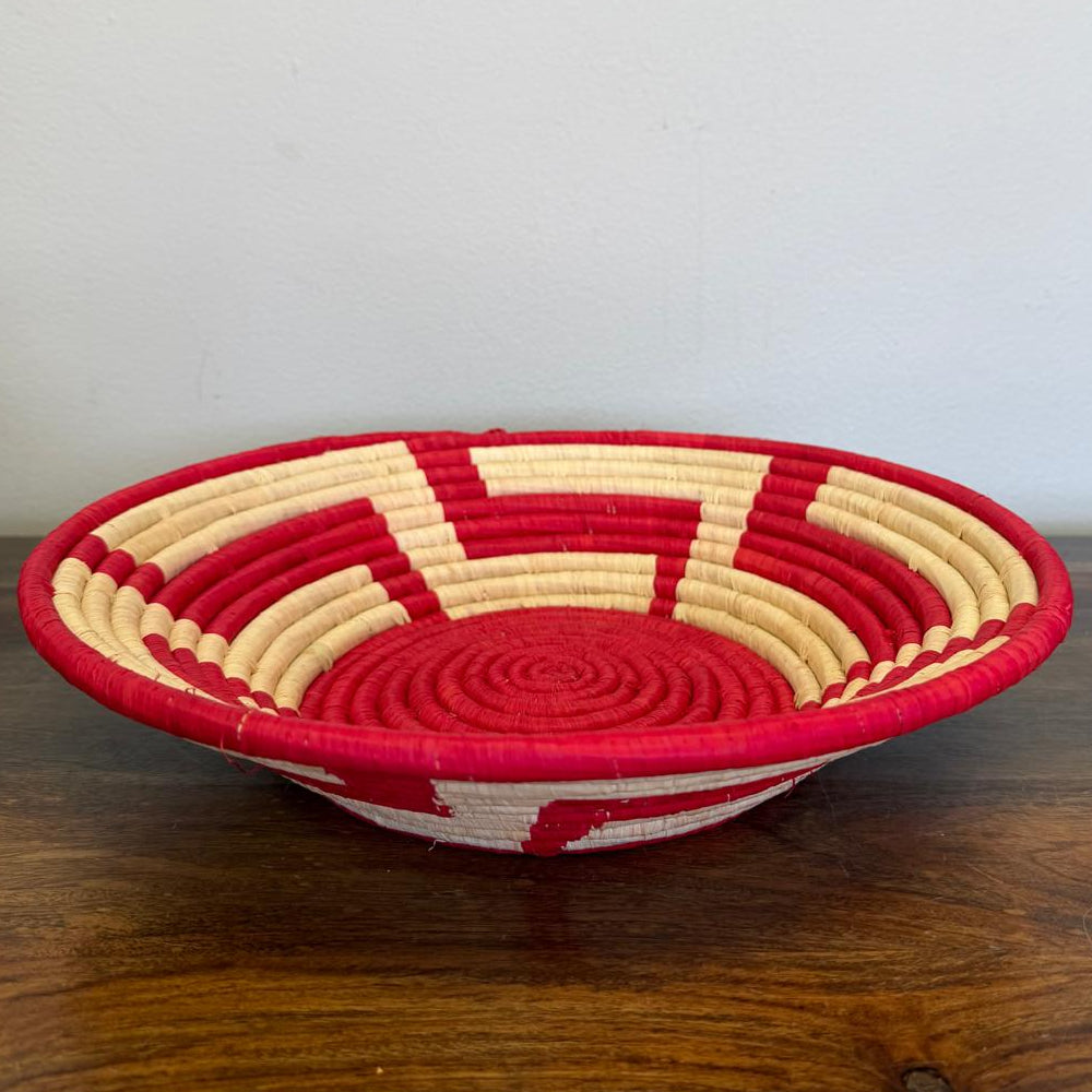 Side view of a Red Radiance Bukedo and Raffia bowl handcrafted in Uganda from banana leaf stalks and palm raffia in vibrant red and natural tones.
