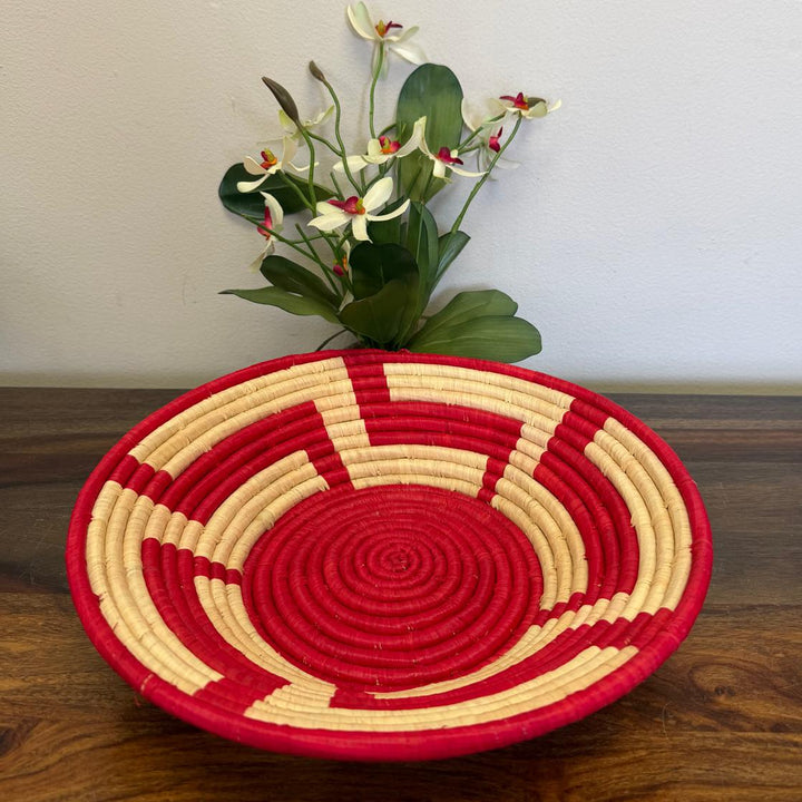 Handwoven Red Radiance Bukedo and Raffia bowl handmade in Uganda featuring vibrant red and natural concentric woven rings for fair trade home décor.