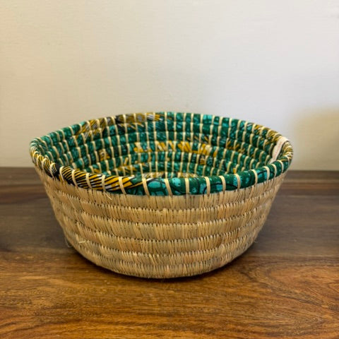 Green trimmed round bread proofing basket. 