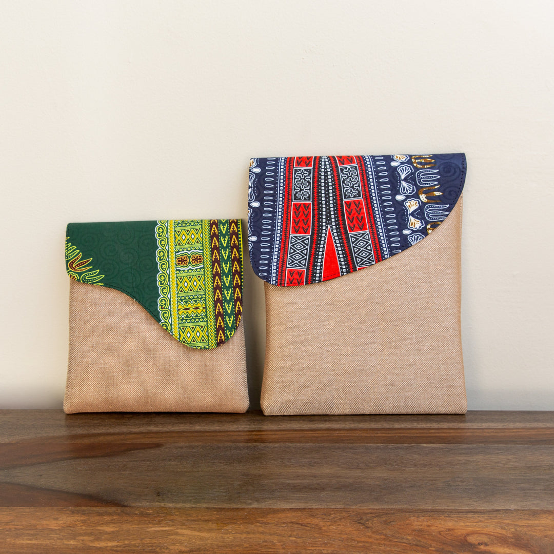 Two African patterned crossbody bags sitting next to each other to show a small and large size.