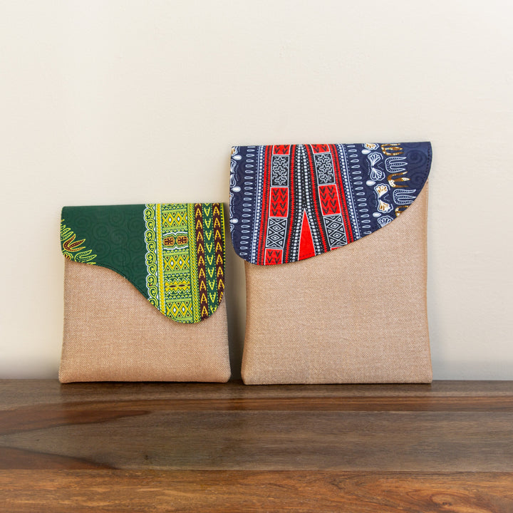 Two African patterned crossbody bags sitting next to each other to show a small and large size.