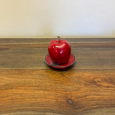 Small 4 inch soapstone bowl holding an apple to show size, handmade in Kenya
