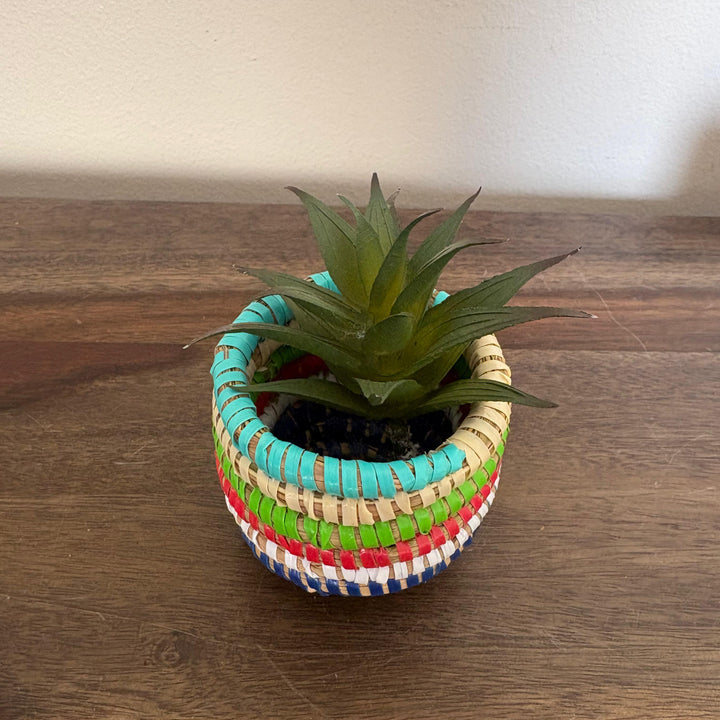 Stackable mini sweetgrass baskets with flat lids for display and storage.