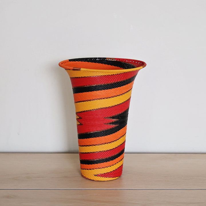 Large Sunset Zulu wire flared vase basket handwoven in South Africa with red, orange, gold and black spiral detailing.
