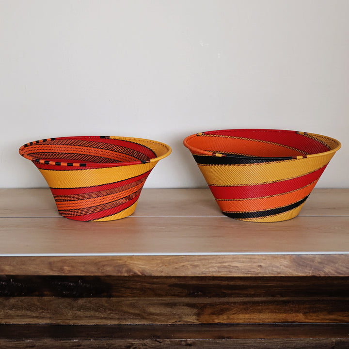 Large funnel handwoven Zulu wire basket in the Sunset colorway with orange, red, yellow and black details.