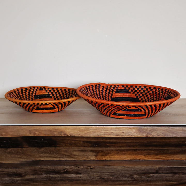 Side view of a Sunstone Check Bukedo and Raffia bowl handcrafted in Uganda from banana leaf stalks and palm raffia with a geometric check pattern.
