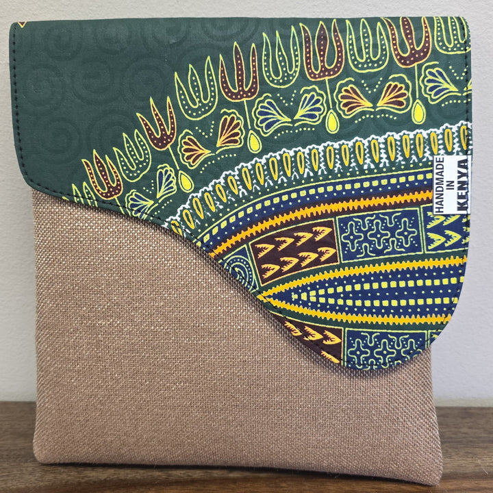taupe crossbody bag with an African printed flap. Bag is unisex.