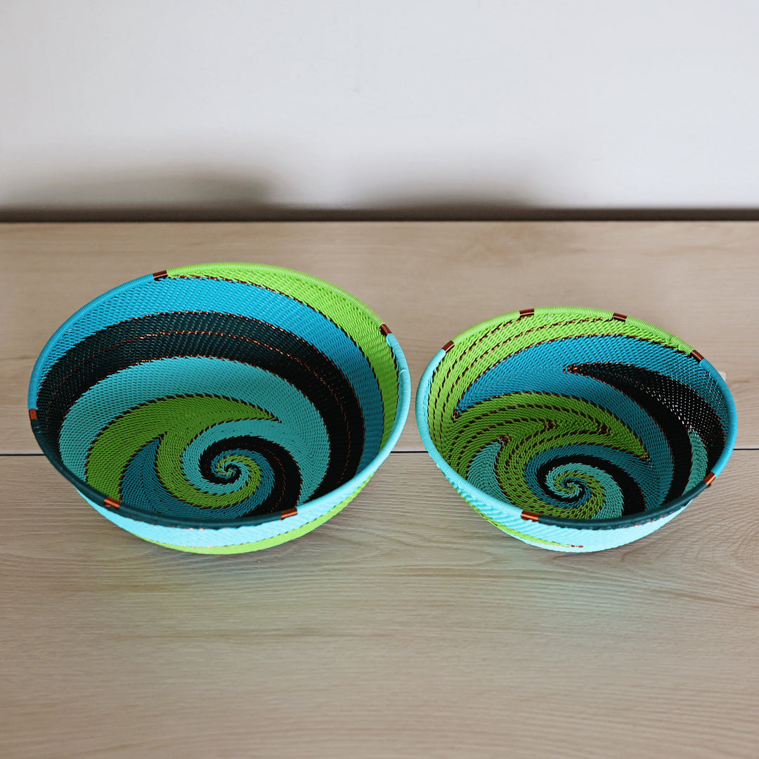 Handwoven Teal Zulu Wire bowls with a bold teal and lime green pattern.