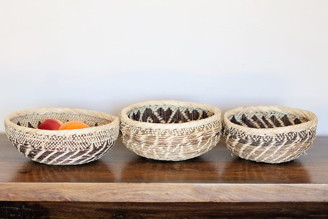 Decorative Tonga basket from Zambia woven with palm leaves and creeping vine structure.