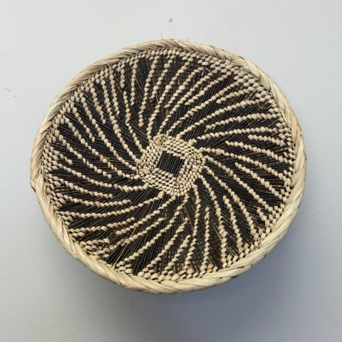 Handwoven fair trade Tonga flat basket bowl from Zambia with rustic woven texture