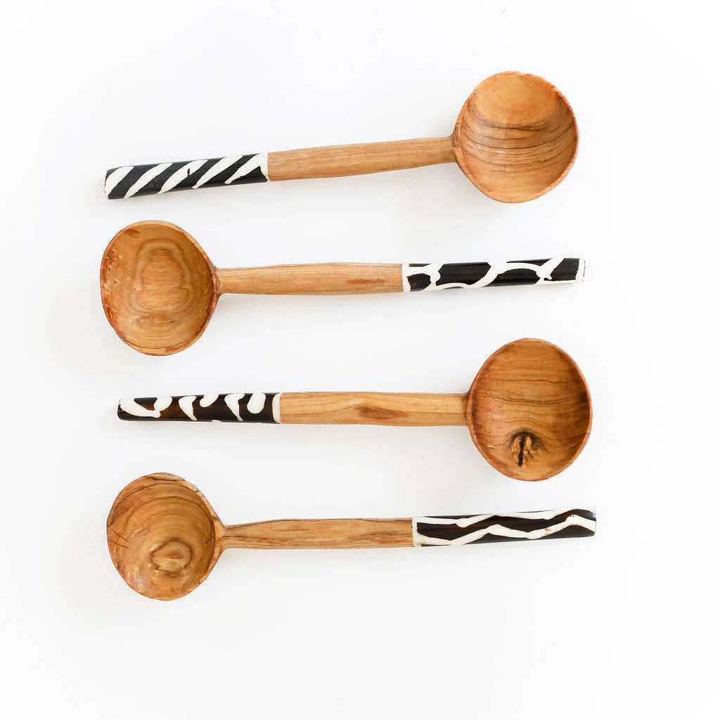 Eco-friendly wood and bone cutlery set handmade by artisans using traditional techniques.