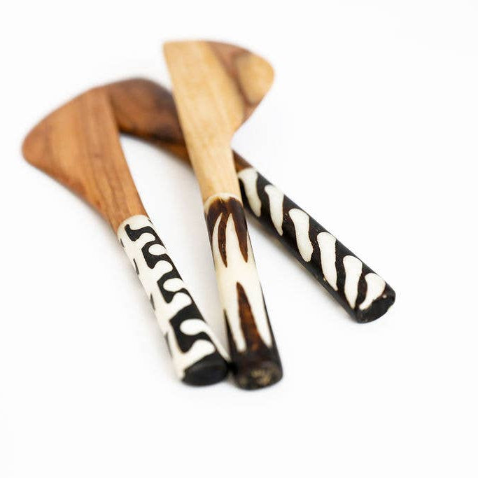 Fair trade wood and bone cutlery set featuring smooth bone handles and natural wood utensils.