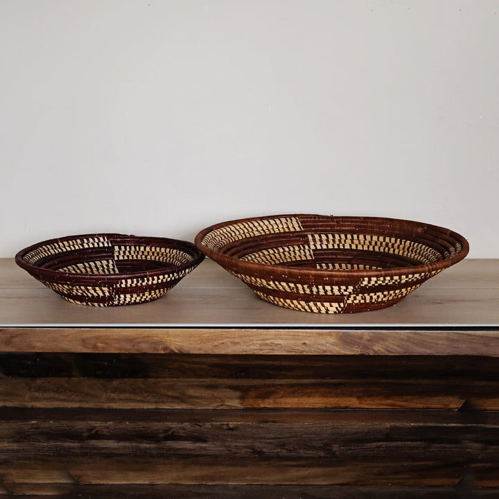 Side view of a Woven Earth Bukedo and Raffia bowl handcrafted in Uganda from banana leaf stalks and palm raffia in rich natural earth tones.