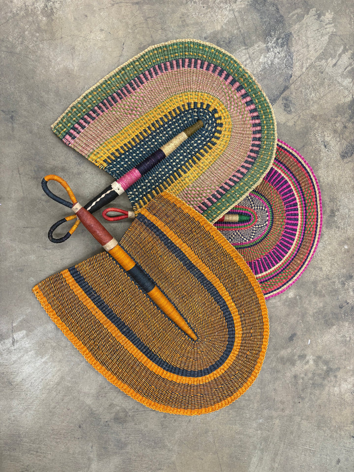 Large African woven fan wall decor, handmade from natural vetiver grass.