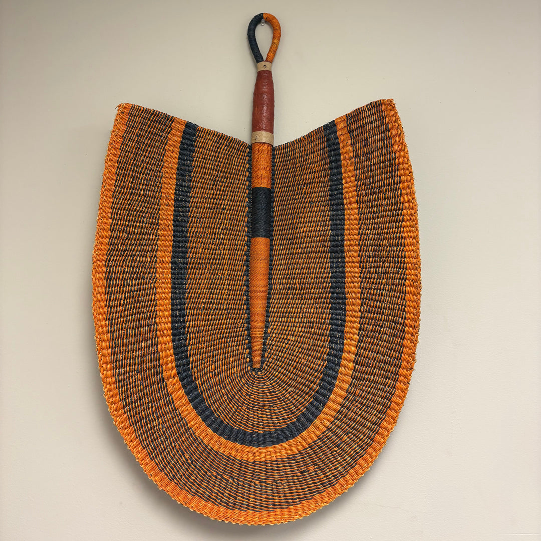 Extra large handwoven grass fan wall decor made from vetiver grass in Ghana.