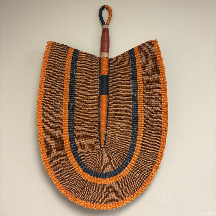 Extra large handwoven grass fan wall decor made from vetiver grass in Ghana.