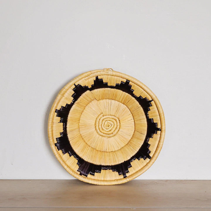 Handwoven Yellow & Black Bukedo and Raffia basket bowl handmade in Uganda for fair trade wall décor and tabletop styling.