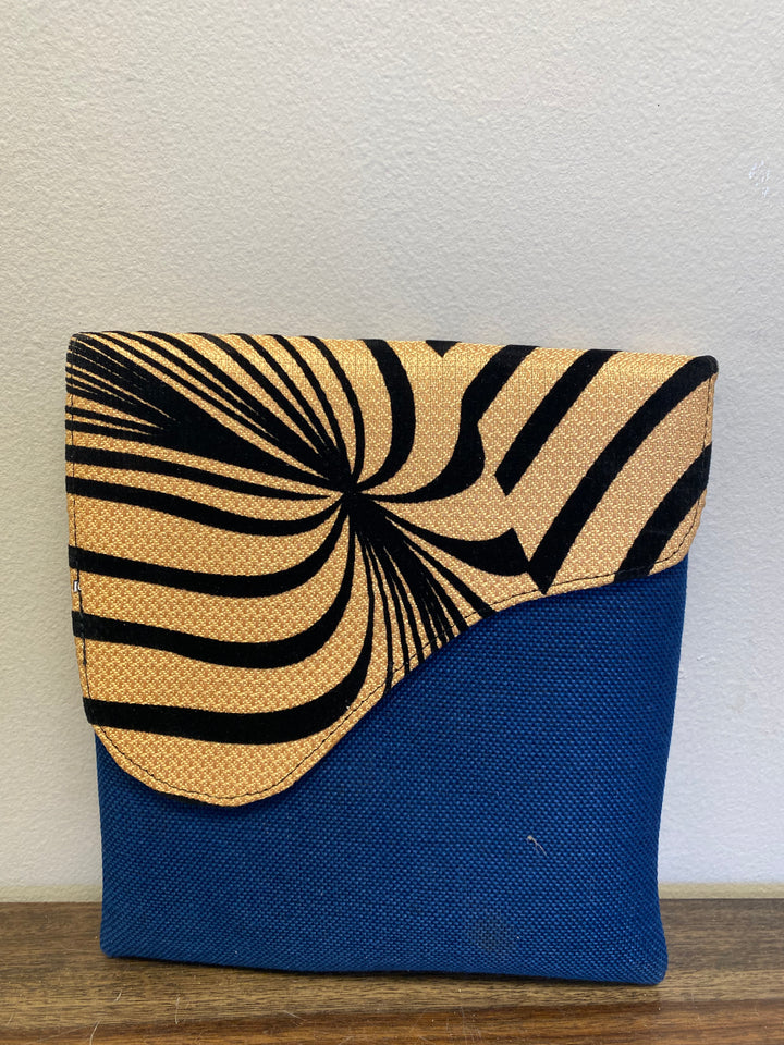 Blue crossbody bag with a zebra printed flap.