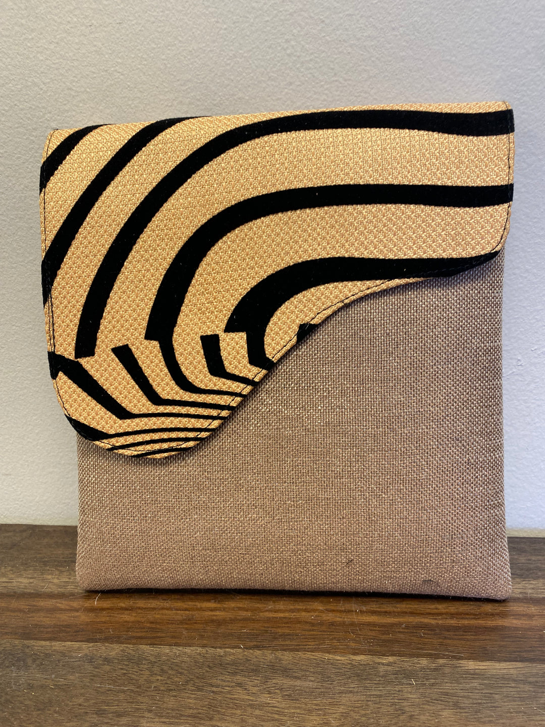Zebra printed flap on a khaki crossbody bag.